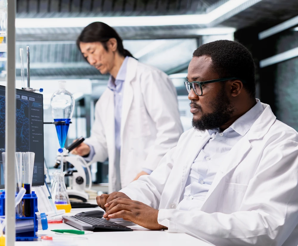 Two doctos working in a lab wearing white coats