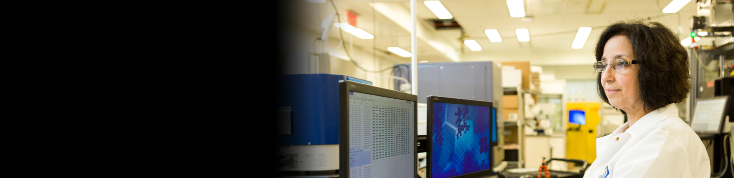Female scientist looks at computer in the lab